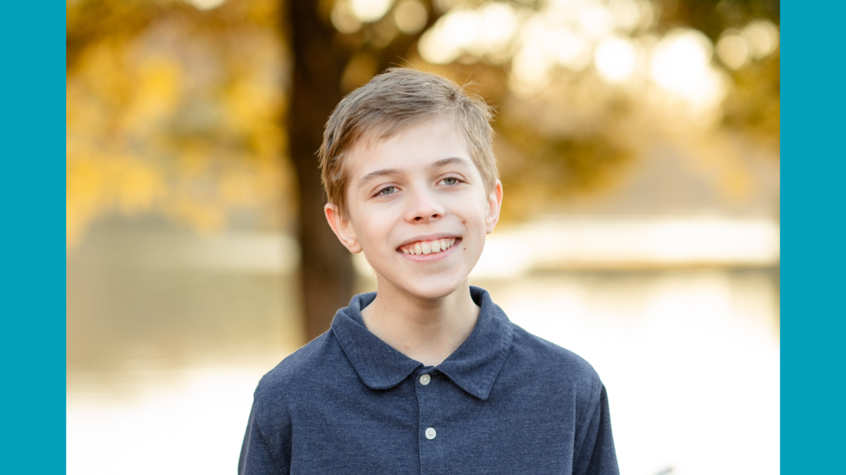 Portrait of Asher smiling, a brave young man fighting fibrolamellar carcinoma